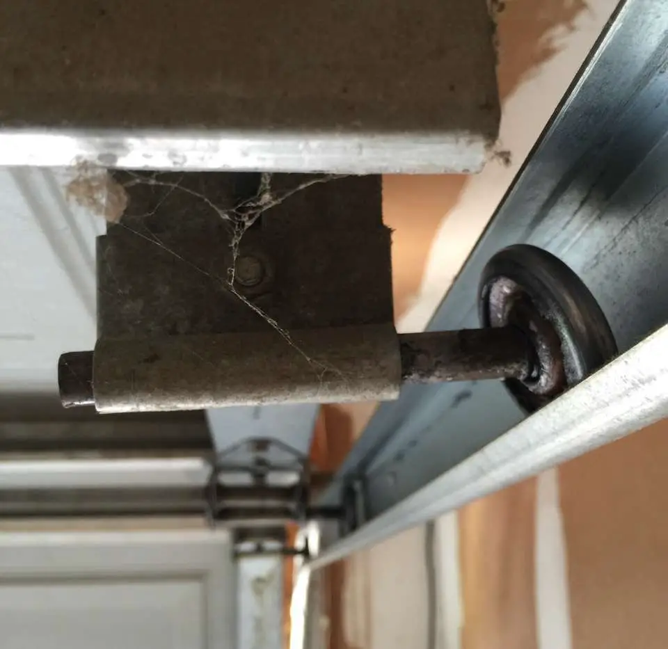 how to fix garage door roller off track