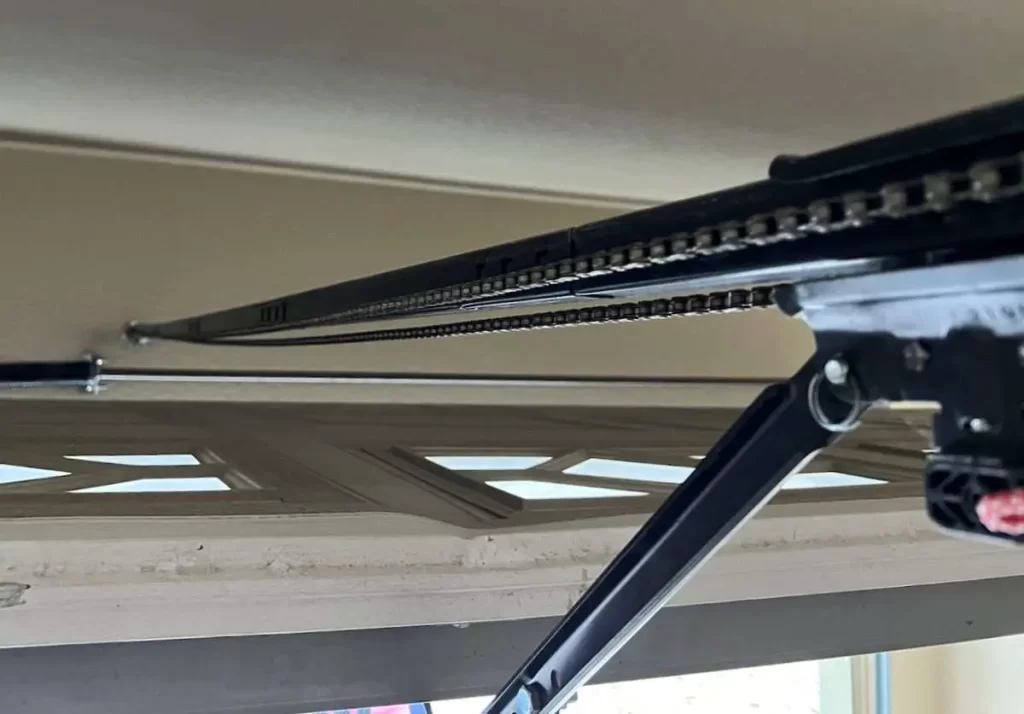 how tight should a garage door chain be